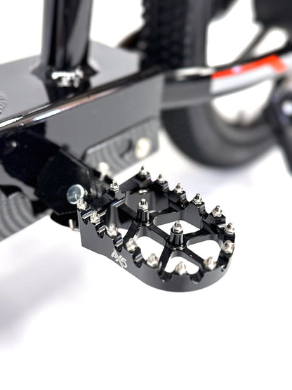 Close-up of metal foot peg with grip studs on electric balance bike