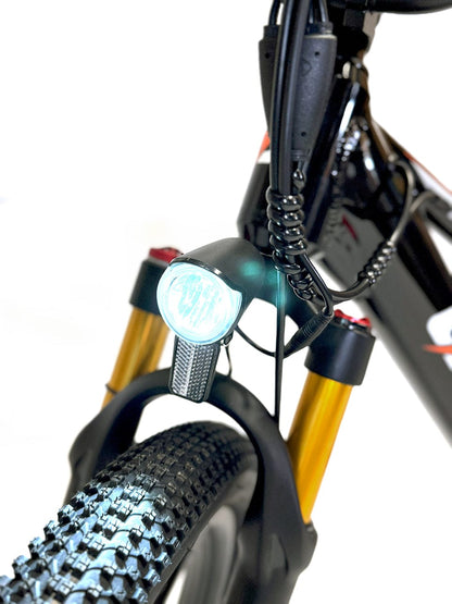 Electric bike front headlight close-up with suspension fork