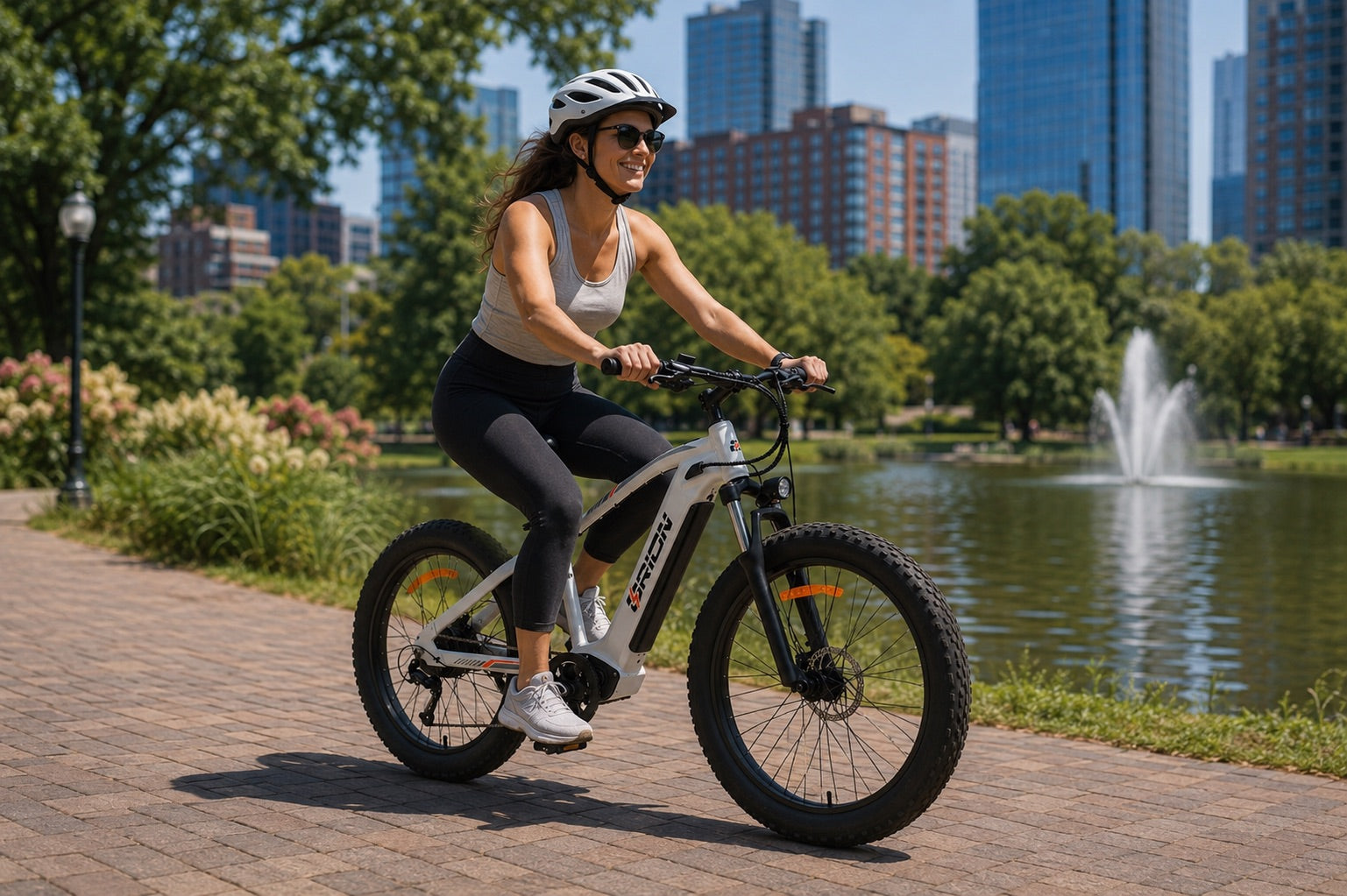Rider enjoying an Orion AT26 electric pedal bike in a city park